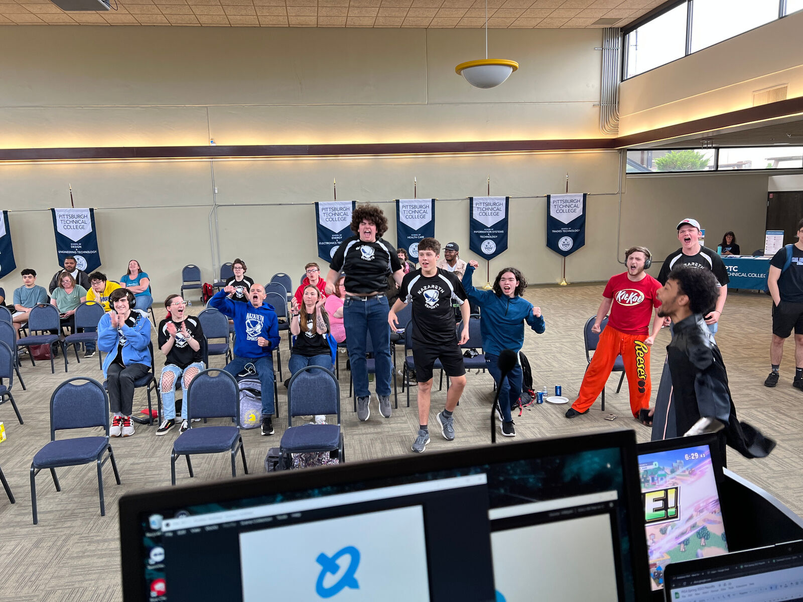 A student competitor in a team jersey at a PIEA LAN event
