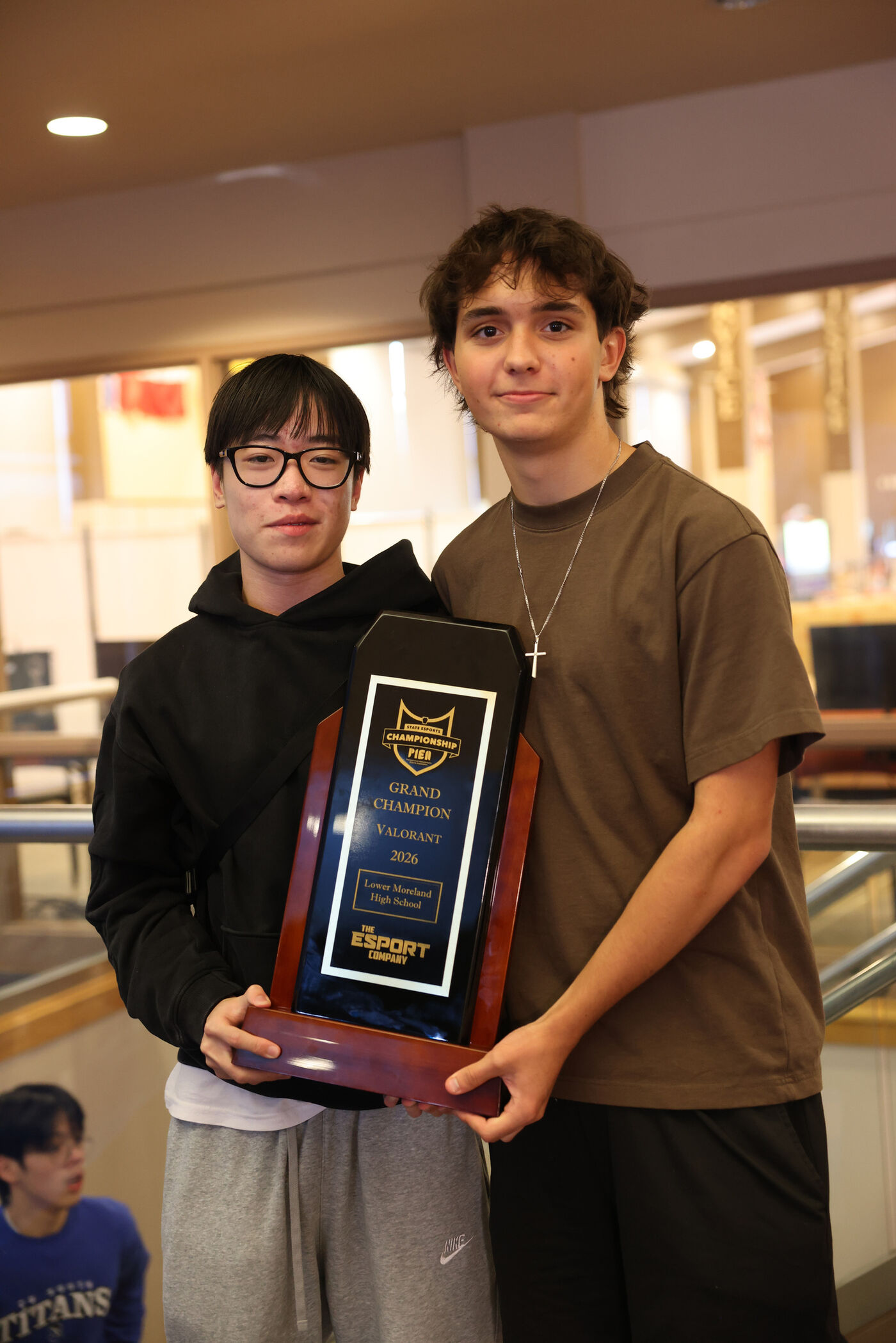 Two students holding a PIEA championship trophy